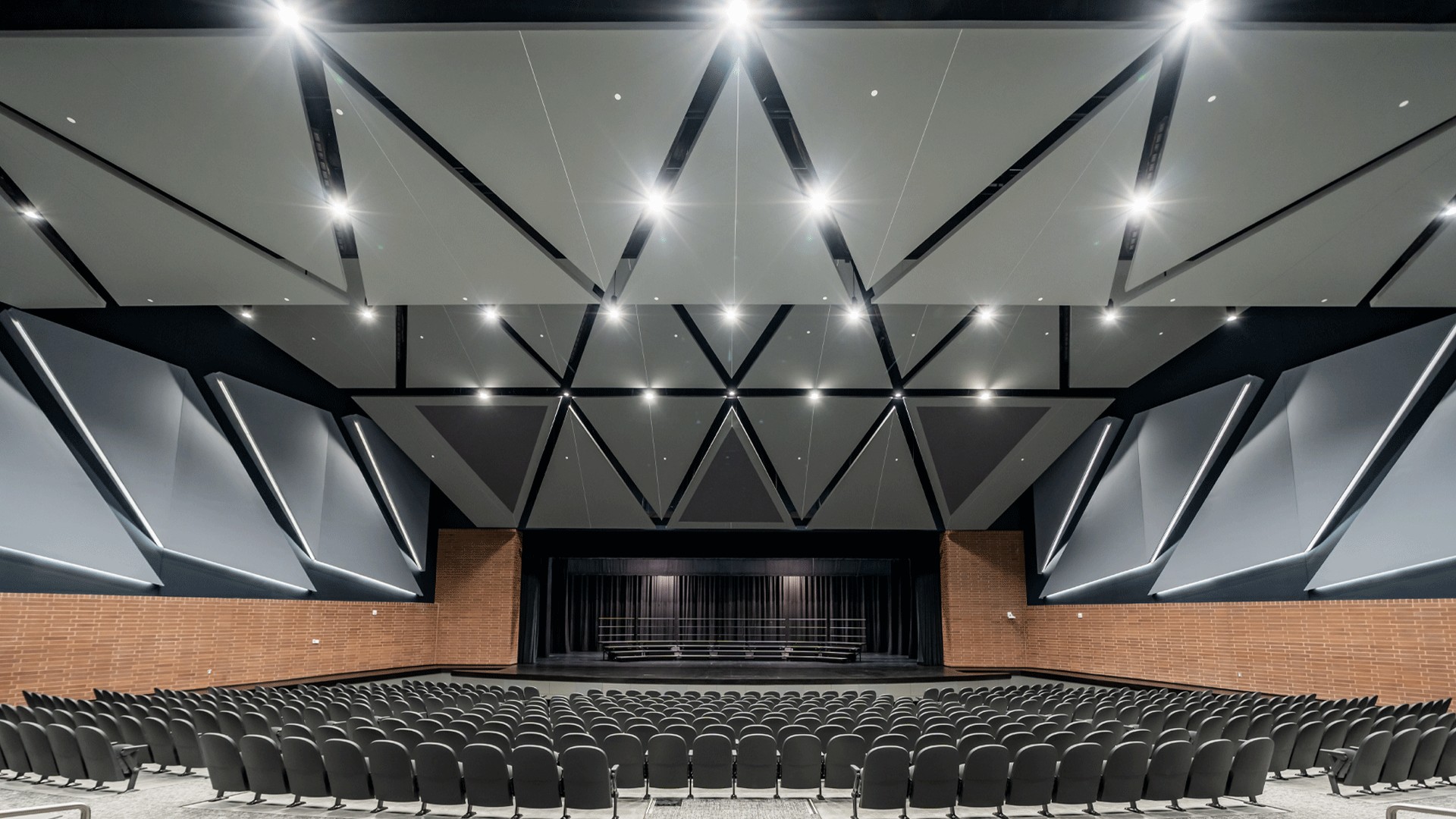 Maize Performing Arts auditorium seating and stage illuminated by architectural house lighting